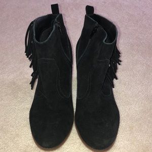 Restricted black suede fringe booties.
